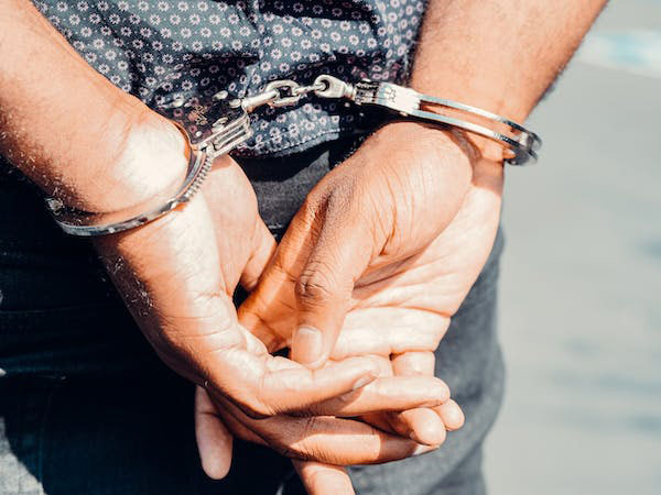 a thief in handcuffs